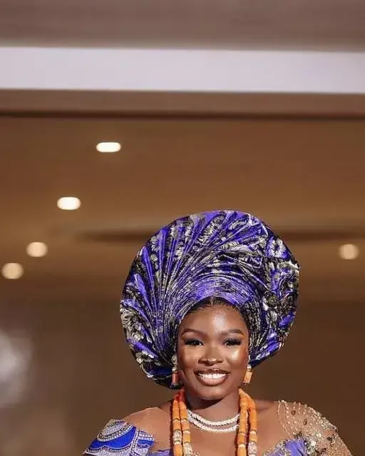 A traditional bride in a purple gele