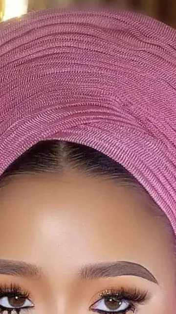 A bride in a pink gele with flawless makeup by Uniktouch
